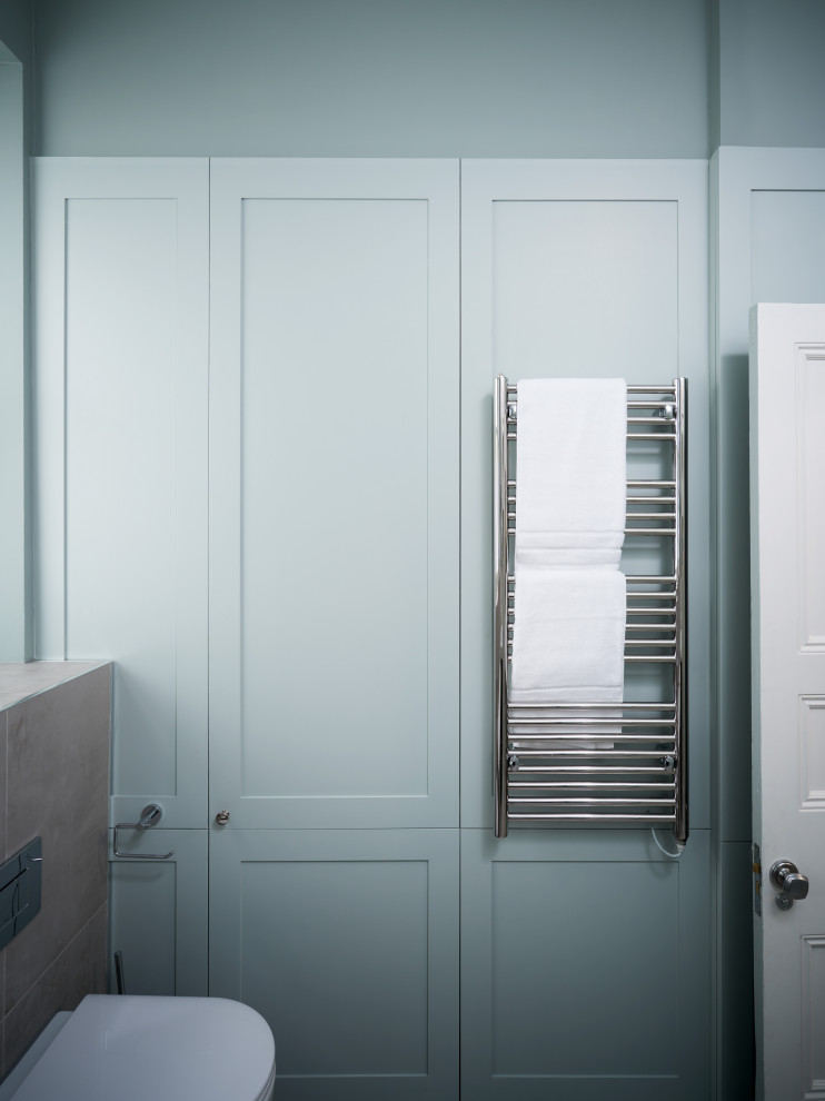 Inspiration for a medium sized contemporary family bathroom in Other with a built-in bath, a walk-in shower, a wall mounted toilet, beige tiles, ceramic tiles, blue walls, ceramic flooring and beige floors.