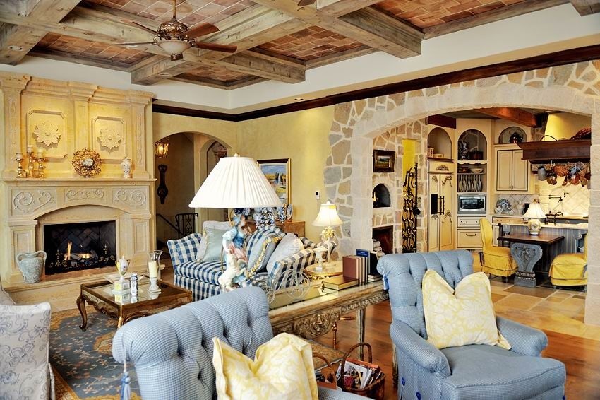 This is an example of a large mediterranean formal open concept living room in Other with yellow walls, medium hardwood floors, a stone fireplace surround and no tv.