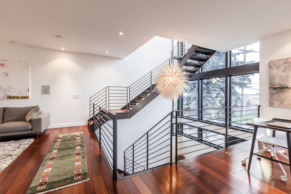 Large contemporary metal floating staircase in Seattle with metal risers.