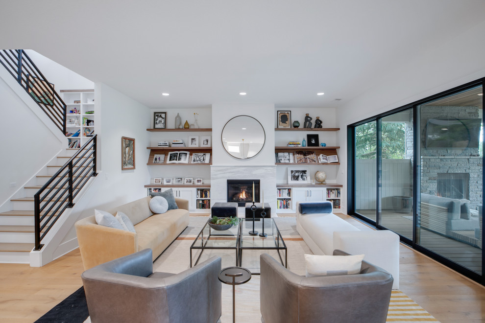 Expansive midcentury formal open concept living room in Portland with white walls, light hardwood floors, a standard fireplace, a stone fireplace surround, no tv and beige floor.