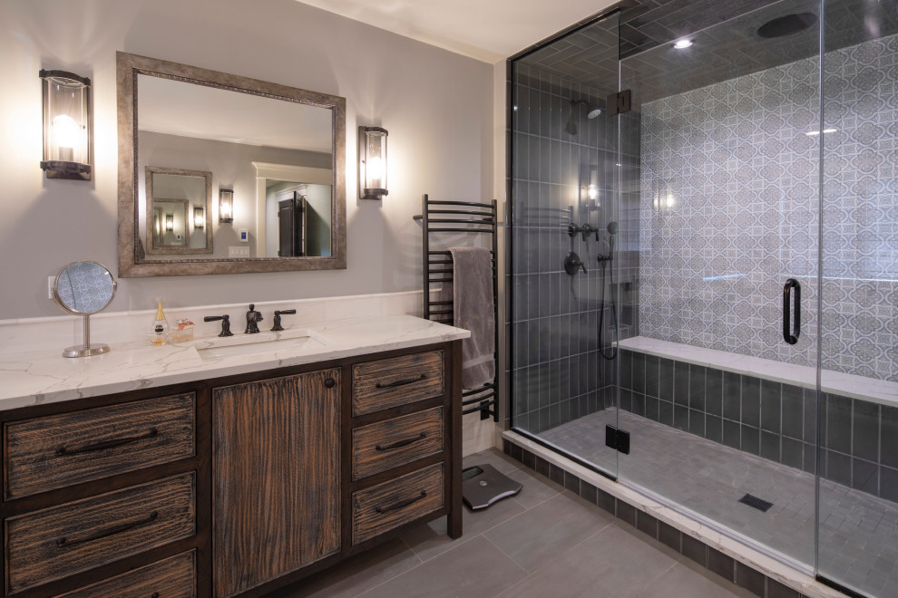 Ensuite bathroom in Chicago with flat-panel cabinets, distressed cabinets, a double shower, multi-coloured tiles, grey walls, a submerged sink, grey floors, a hinged door, white worktops, a shower bench, a single sink and a freestanding vanity unit.