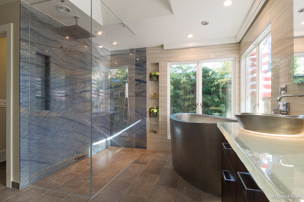 This is an example of a transitional master bathroom in San Francisco with flat-panel cabinets, dark wood cabinets, a japanese tub, a curbless shower, beige tile, porcelain tile, beige walls, porcelain floors, a pedestal sink, recycled glass benchtops, brown floor, an open shower and white benchtops.