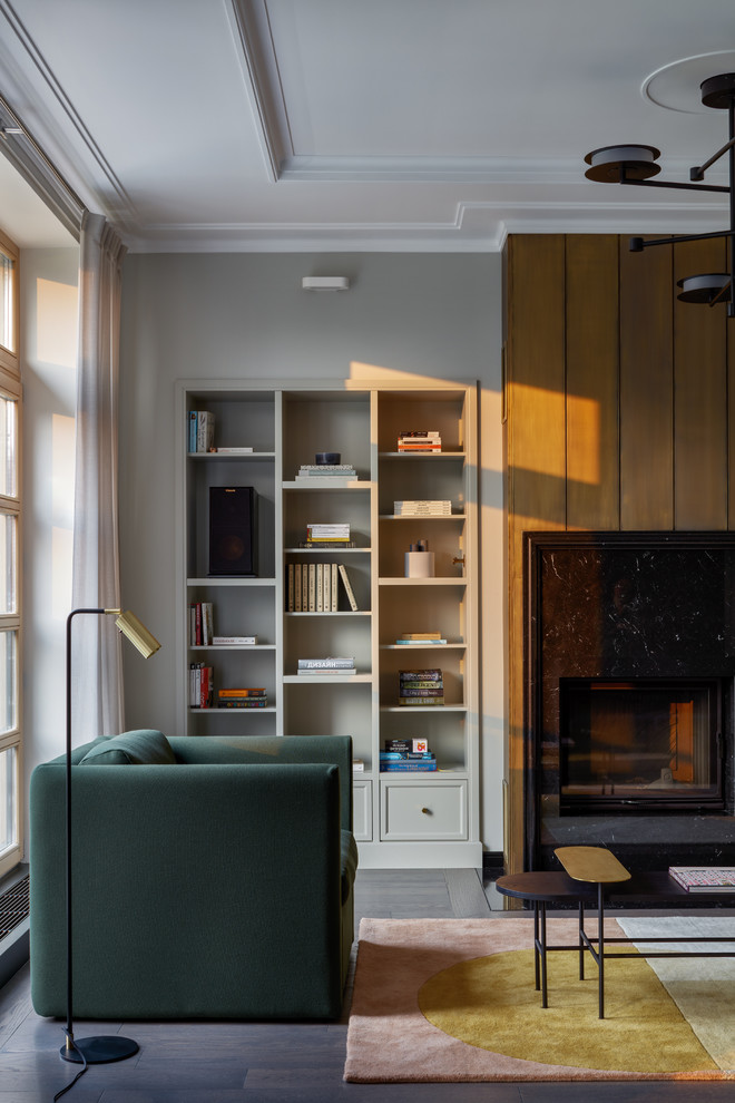 Inspiration for a large contemporary enclosed living room in Moscow with a library, dark hardwood floors, a standard fireplace, a metal fireplace surround, a freestanding tv and brown floor.