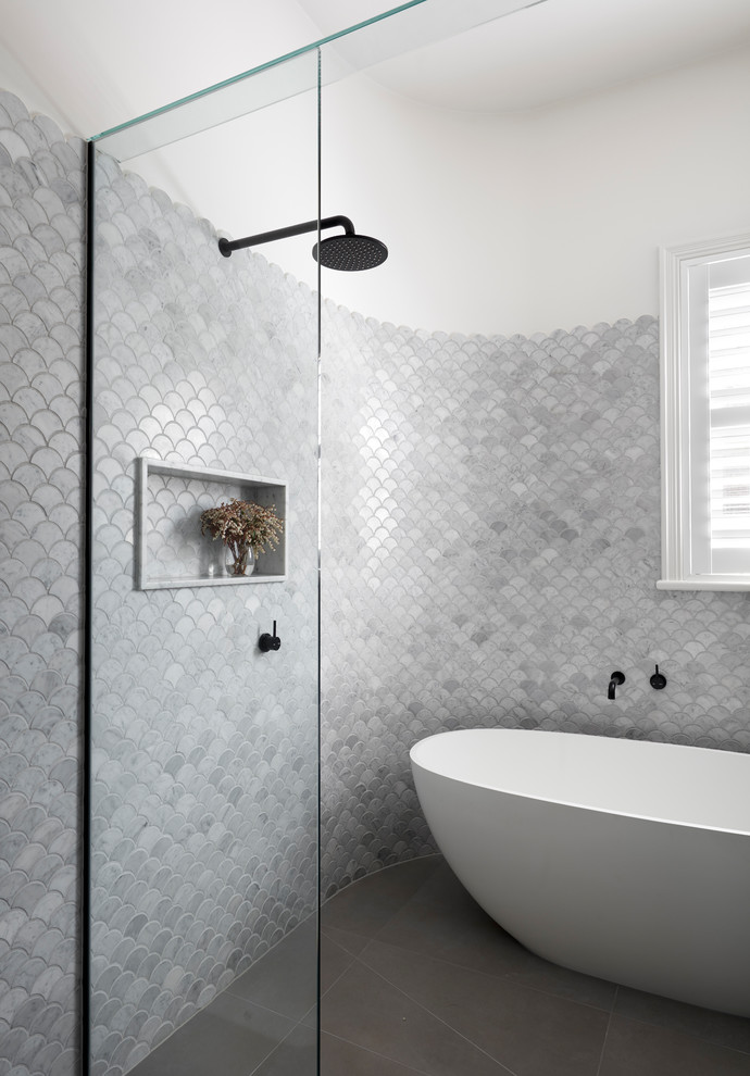 Inspiration for a mid-sized contemporary 3/4 bathroom in Melbourne with a freestanding tub, a one-piece toilet, multi-coloured tile, white walls, porcelain floors, grey floor, a hinged shower door, flat-panel cabinets, beige cabinets, an open shower, pebble tile, an integrated sink, laminate benchtops and white benchtops.