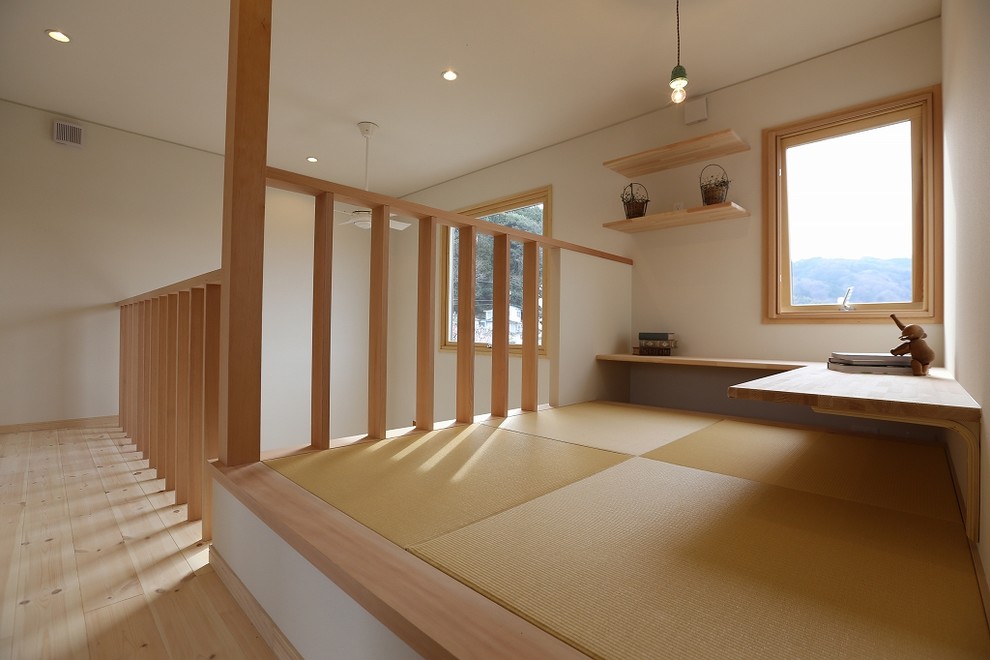 This is an example of a small scandinavian study room in Other with white walls, tatami floors, no fireplace and a built-in desk.