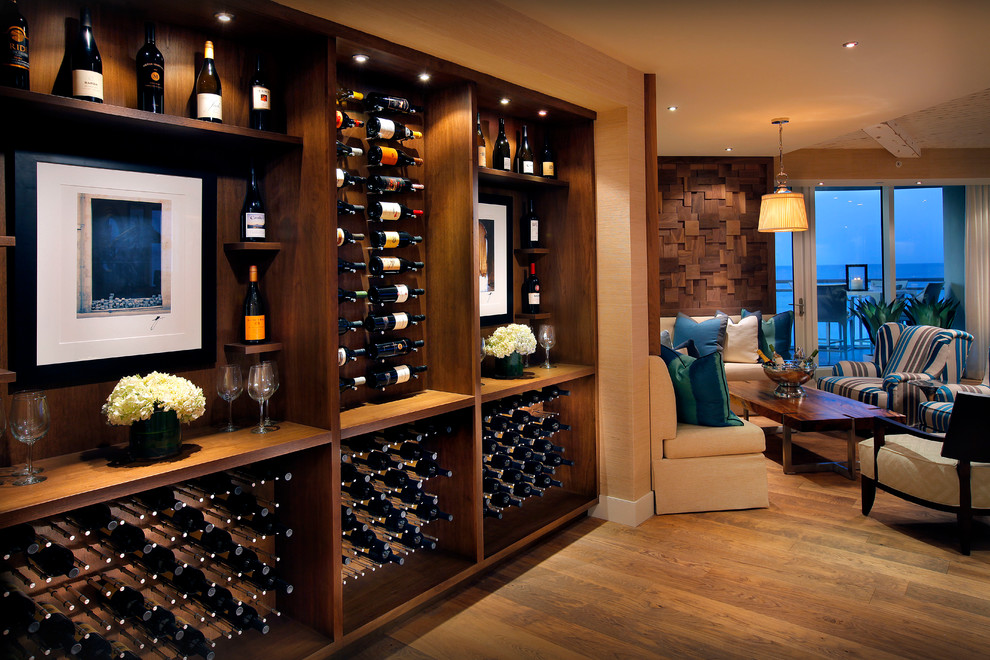 Photo of a mid-sized contemporary wine cellar in Miami with medium hardwood floors, storage racks and yellow floor.