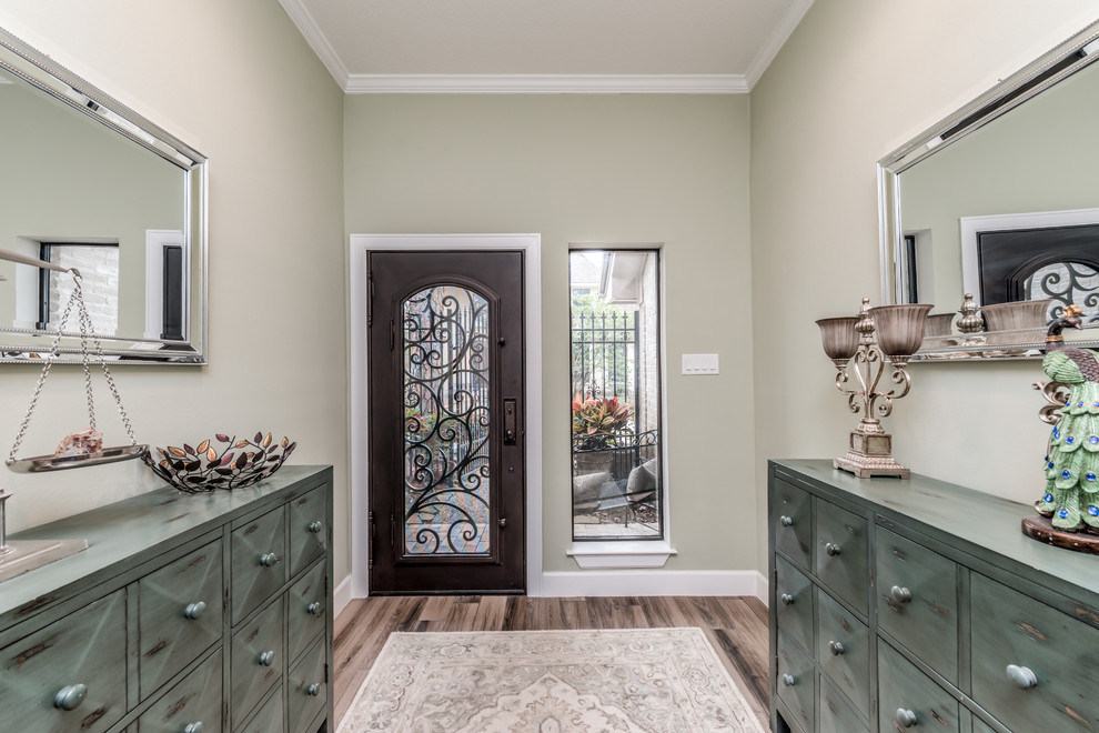 Photo of a large traditional front door in Houston with beige walls, porcelain floors, a single front door, a metal front door and brown floor.