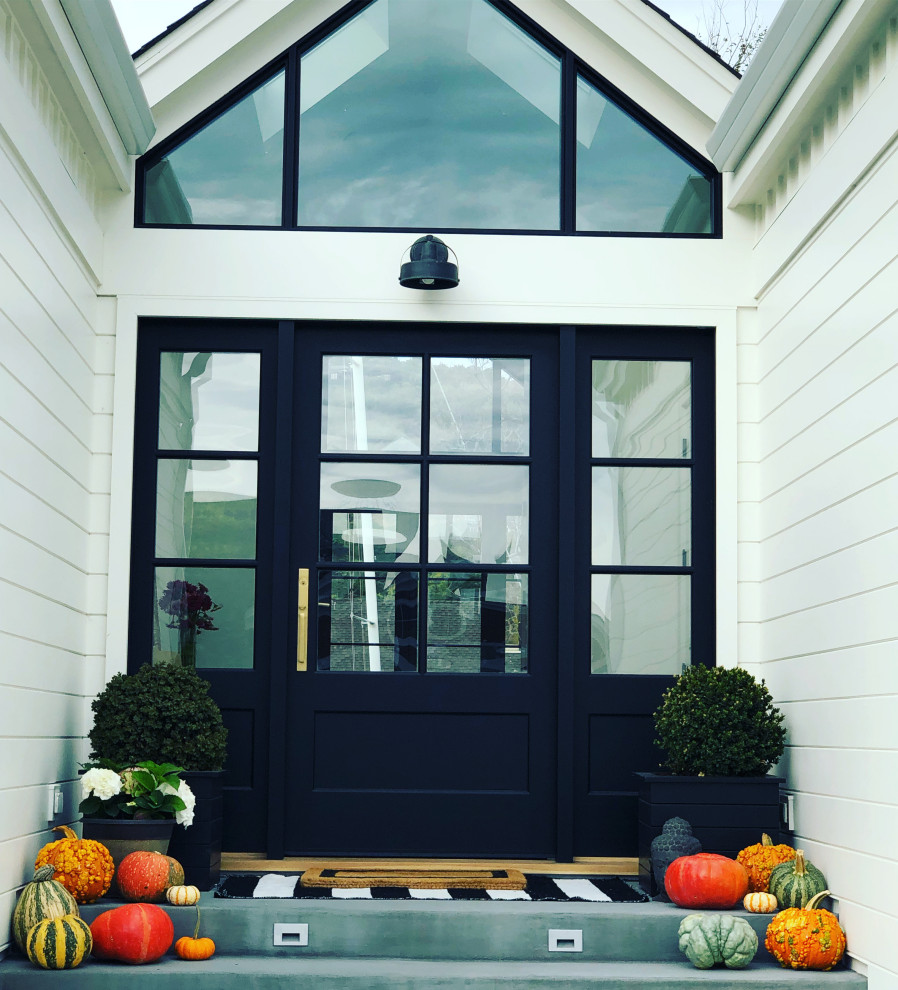 Inspiration for a large coastal white one-story concrete fiberboard and board and batten gable roof remodel with a shingle roof