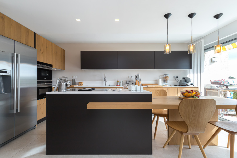 Design ideas for a large contemporary open plan kitchen in Nice with beaded inset cabinets, light wood cabinets, solid surface benchtops, white splashback, with island and white benchtop.