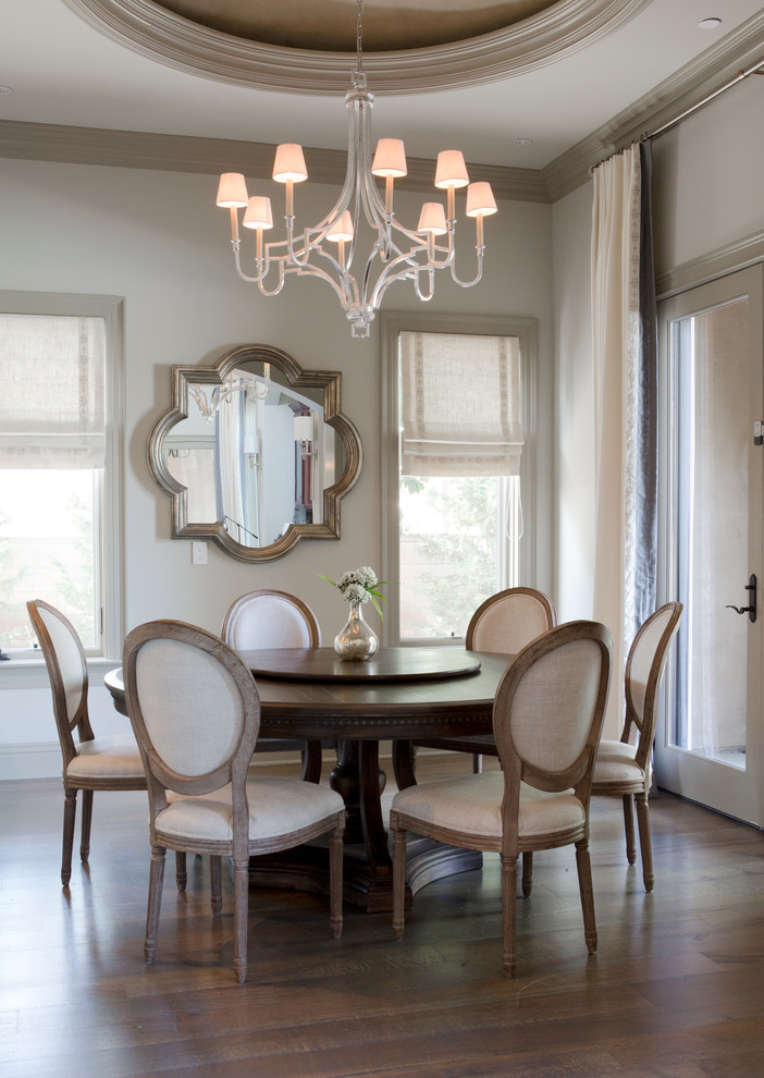 Inspiration for a transitional dining room in Los Angeles with beige walls, dark hardwood floors and no fireplace.