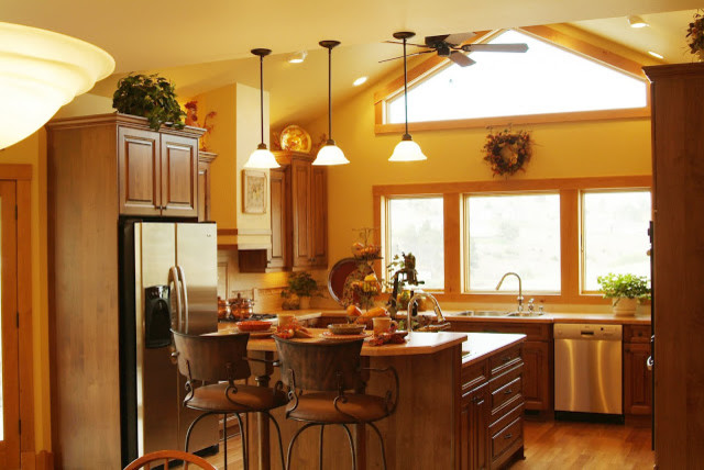 Inspiration for a large rustic u-shaped medium tone wood floor eat-in kitchen remodel with a double-bowl sink, beaded inset cabinets, medium tone wood cabinets, granite countertops, beige backsplash, stainless steel appliances and an island