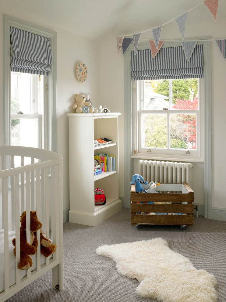 Design ideas for a transitional gender-neutral kids' room in London with white walls and carpet.
