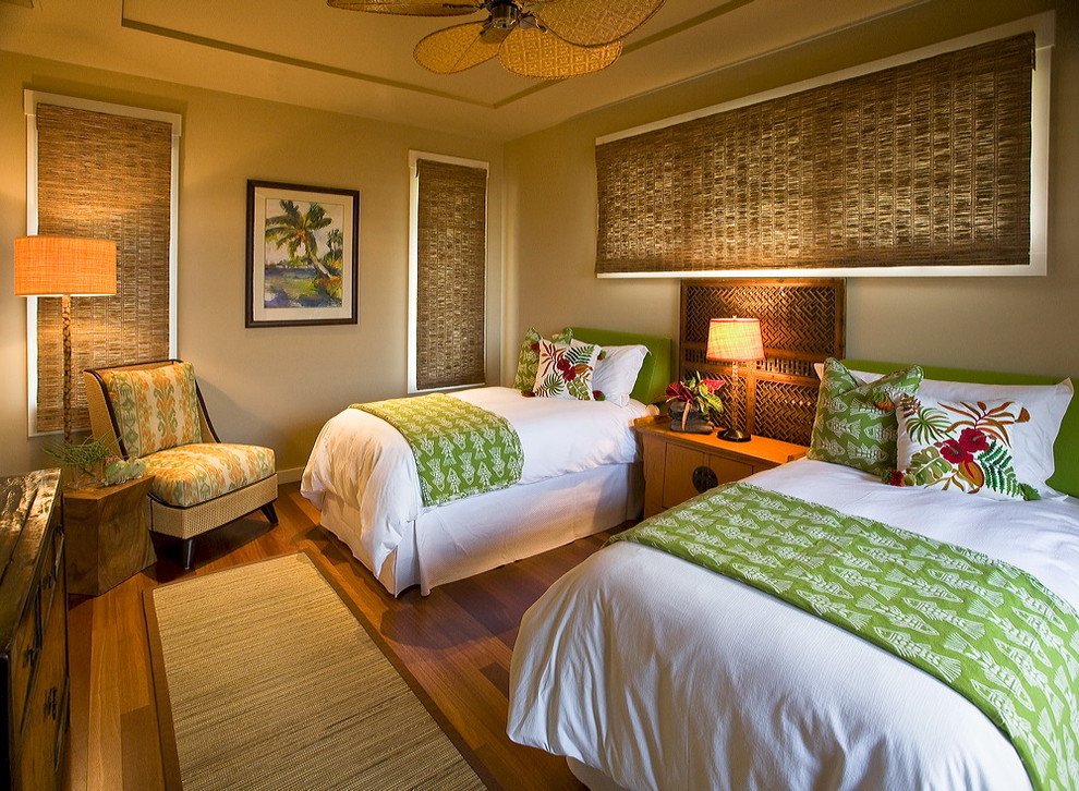 Design ideas for a tropical guest bedroom in Hawaii with grey walls and dark hardwood floors.