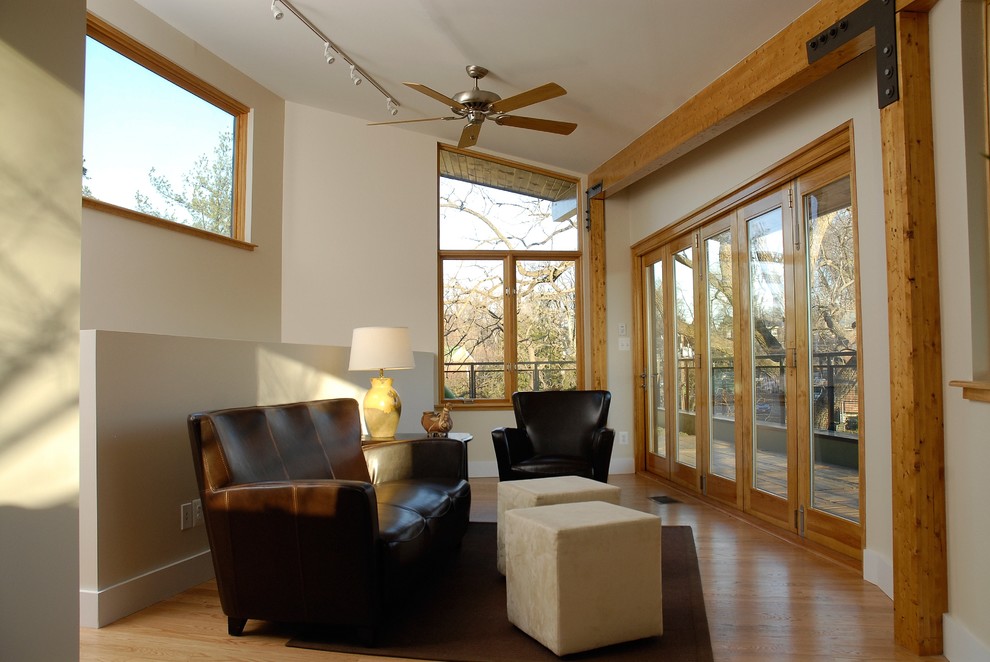 Photo of a mid-sized modern sunroom in DC Metro with light hardwood floors and a standard ceiling.