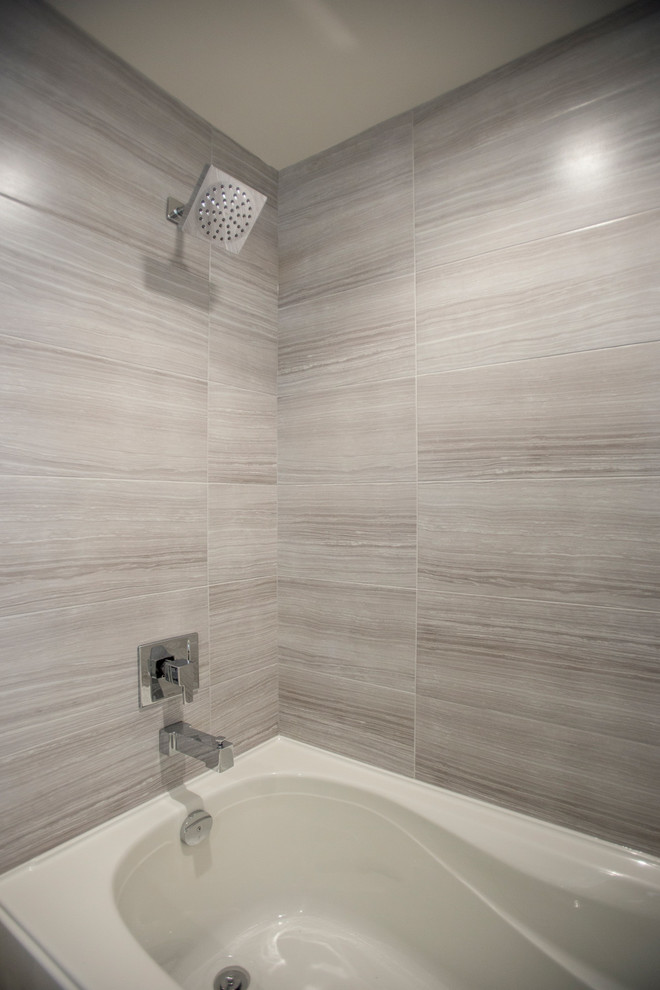 Photo of a mid-sized modern 3/4 bathroom in Vancouver with shaker cabinets, white cabinets, an alcove tub, a shower/bathtub combo, a two-piece toilet, beige tile, gray tile, matchstick tile, blue walls, an undermount sink and granite benchtops.