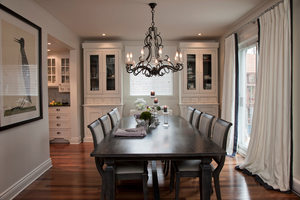 Traditional dining room in Montreal with dark hardwood floors.