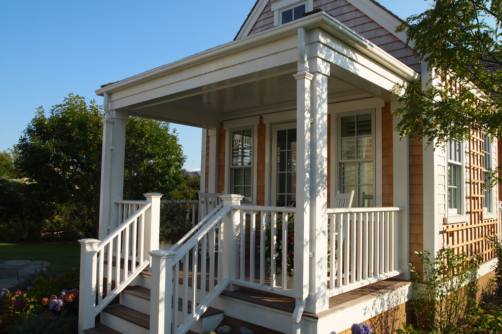 Mid-sized traditional front yard verandah in Boston with decking and a roof extension.