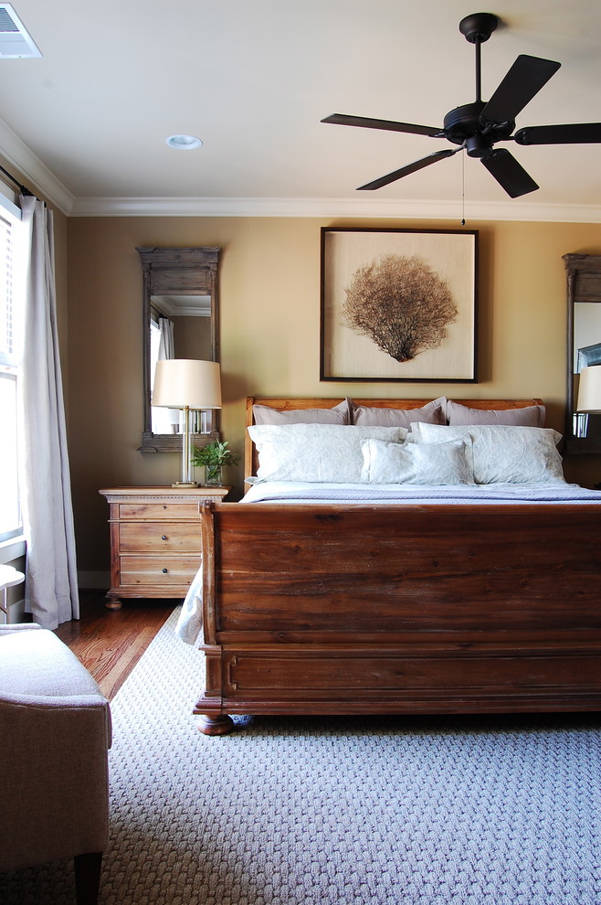 Inspiration for a beach style master bedroom in New York with beige walls and medium hardwood floors.