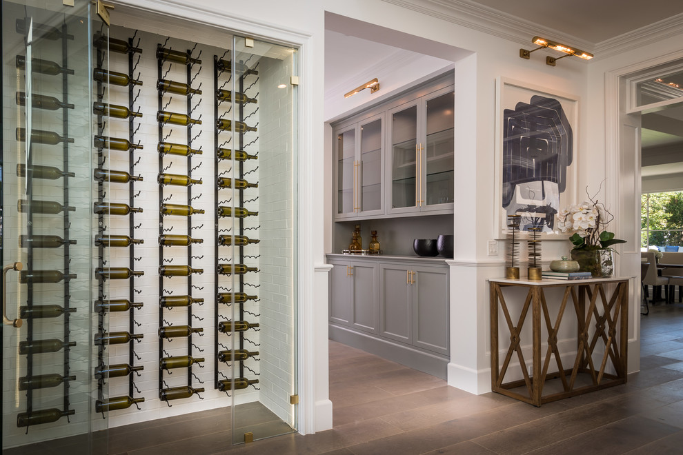 Design ideas for a large traditional wine cellar in Los Angeles with medium hardwood floors, display racks and brown floor.