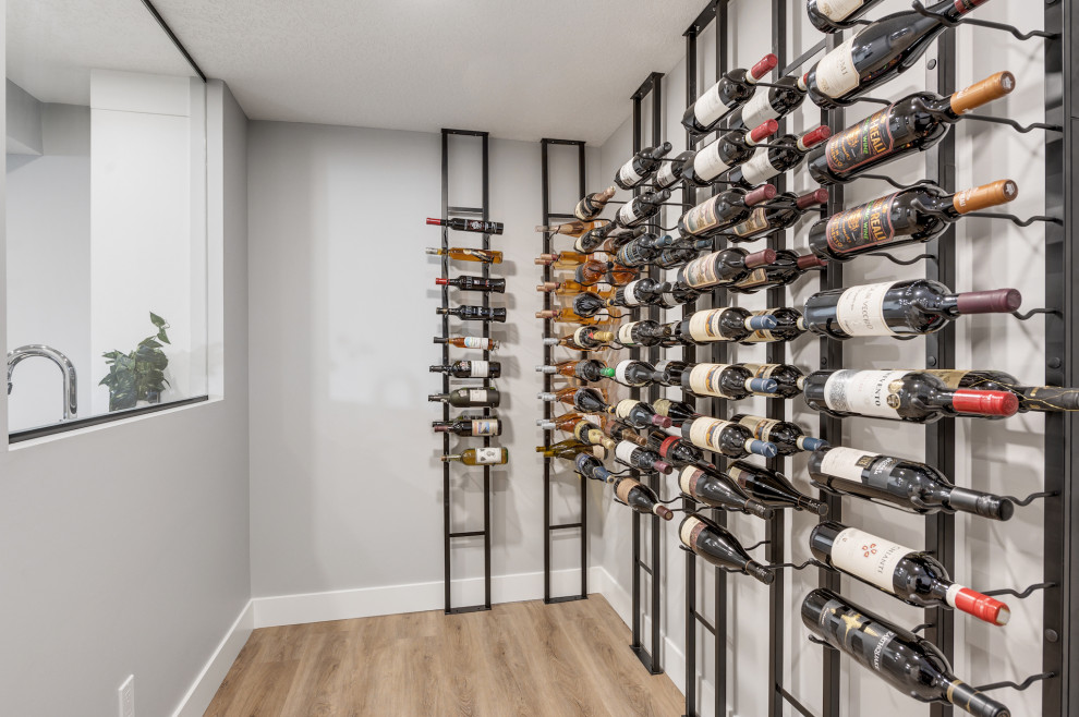 Inspiration for a small contemporary wine cellar in Calgary with vinyl floors, storage racks and brown floor.