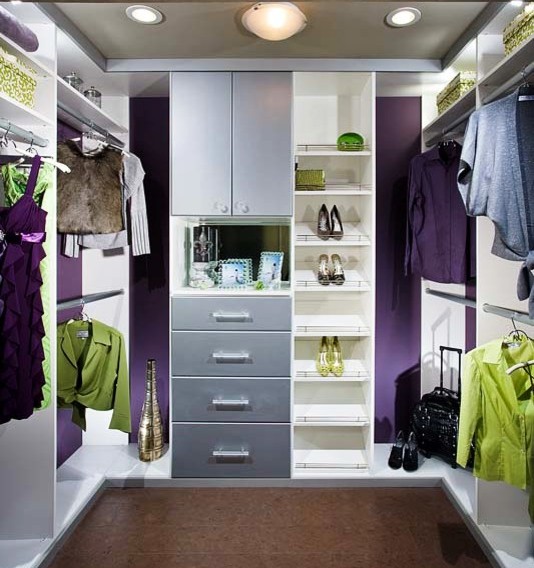 Design ideas for a mid-sized transitional women's walk-in wardrobe in Los Angeles with flat-panel cabinets and grey cabinets.