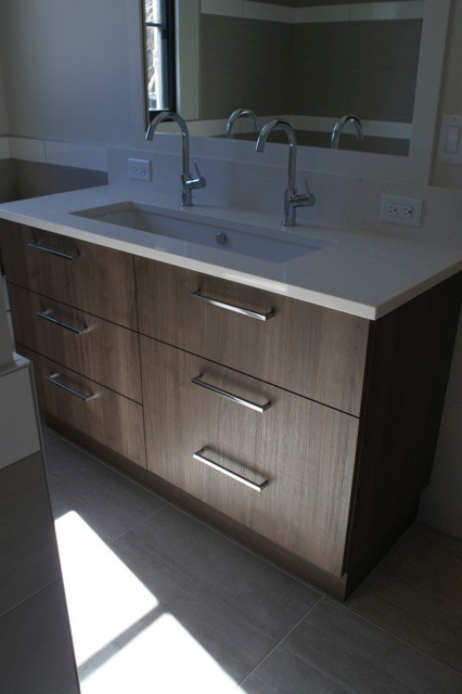Design ideas for a modern bathroom in Denver with flat-panel cabinets and medium wood cabinets.