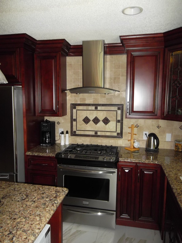 Kitchen - mid-sized transitional l-shaped ceramic tile kitchen idea with a drop-in sink, dark wood cabinets, granite countertops, stone tile backsplash, stainless steel appliances, an island and raised-panel cabinets