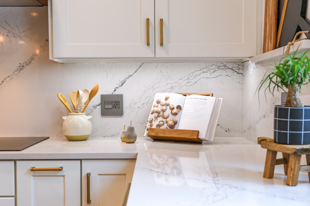 Large transitional u-shaped light wood floor and brown floor eat-in kitchen photo in Chicago with an undermount sink, shaker cabinets, white cabinets, quartz countertops, white backsplash, quartz backsplash, paneled appliances, an island and white countertops