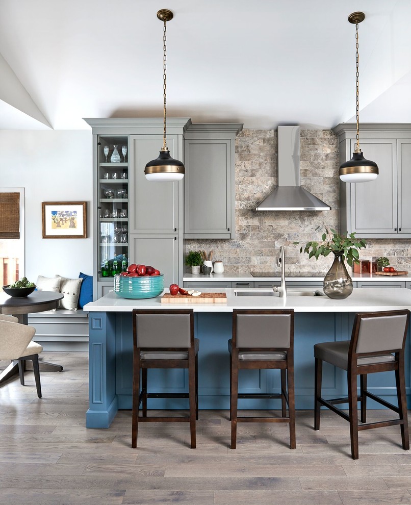 Photo of a mid-sized transitional galley eat-in kitchen in Toronto with an undermount sink, shaker cabinets, quartzite benchtops, grey splashback, stone tile splashback, stainless steel appliances, with island, blue cabinets, light hardwood floors and beige floor.