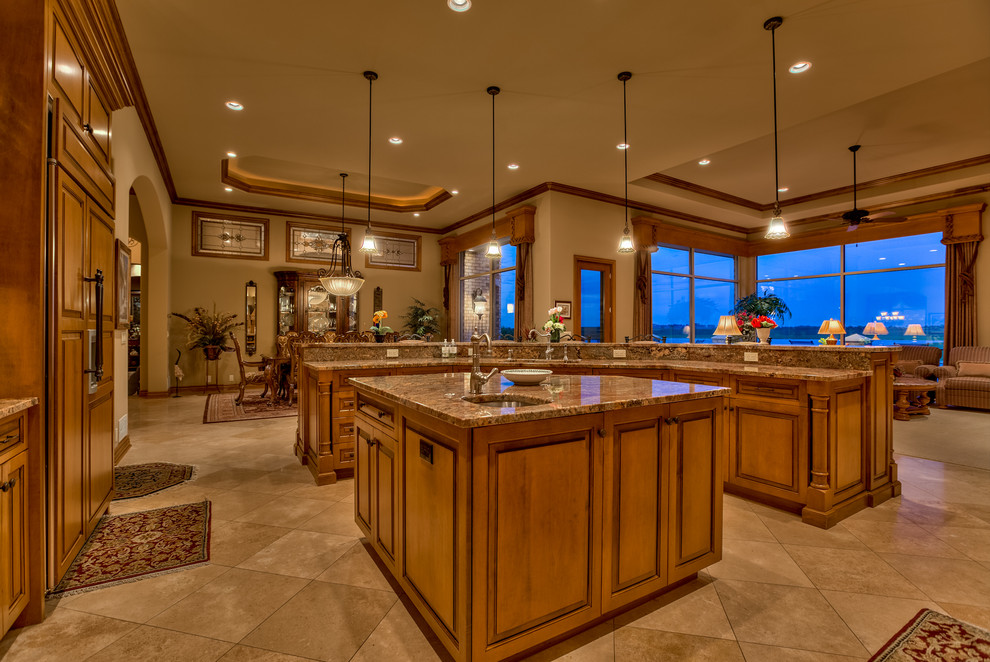 Large traditional l-shaped eat-in kitchen in Omaha with an undermount sink, recessed-panel cabinets, medium wood cabinets, granite benchtops, brown splashback, stone slab splashback, stainless steel appliances, porcelain floors, multiple islands and beige floor.