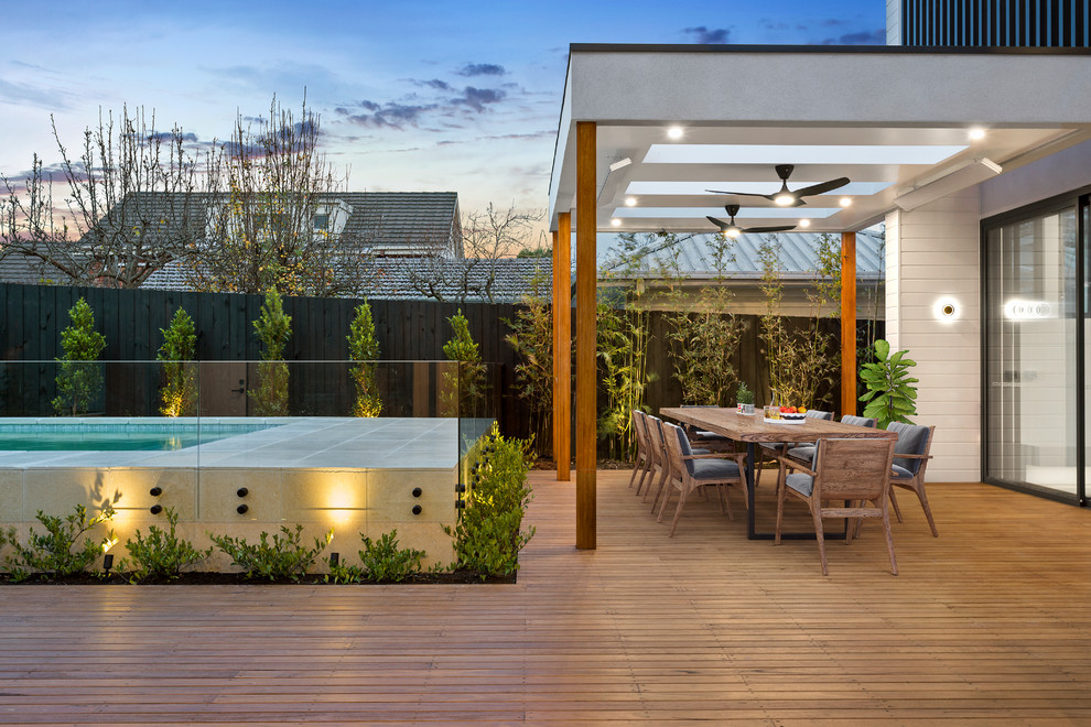 Inspiration for a contemporary backyard deck in Melbourne with a roof extension.