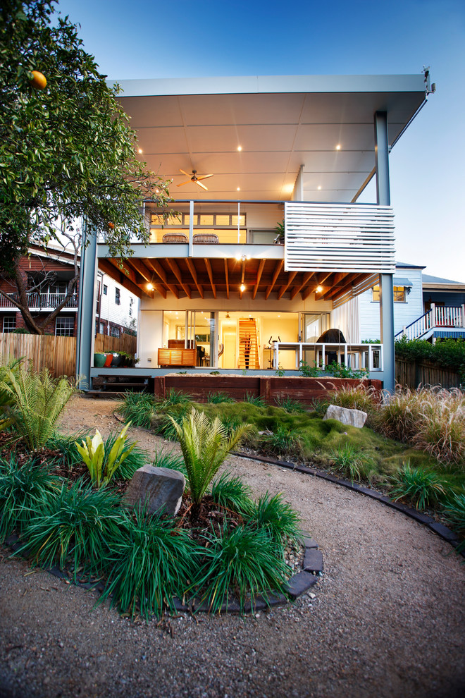 Photo of a large transitional two-storey white house exterior in Brisbane with a flat roof.