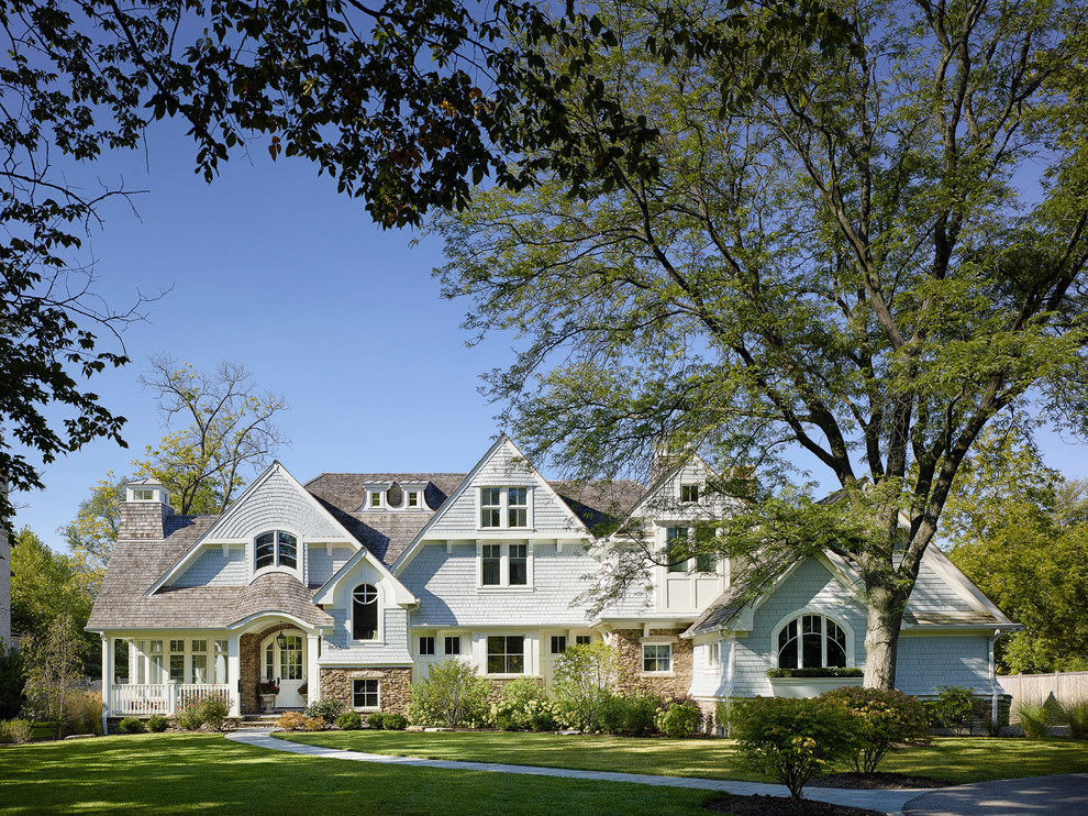 Inspiration for a large traditional two-storey blue exterior in Chicago with wood siding and a gable roof.