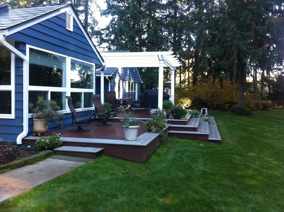 Deck - transitional backyard deck idea in Seattle with a pergola