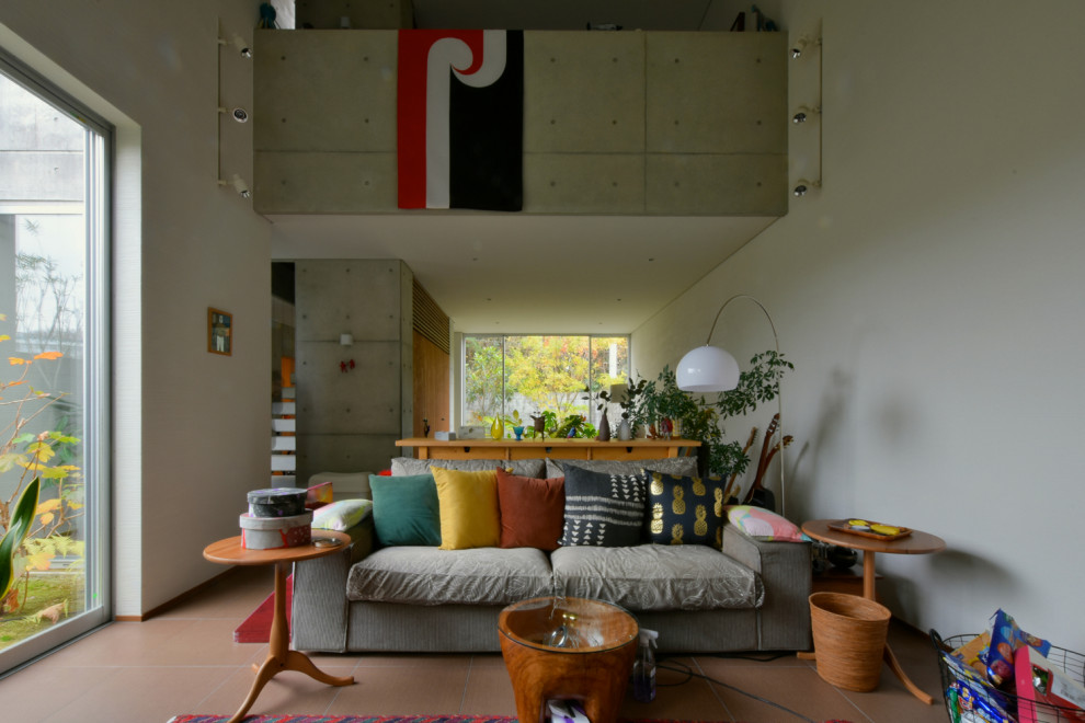 This is an example of an industrial living room in Other with grey walls.