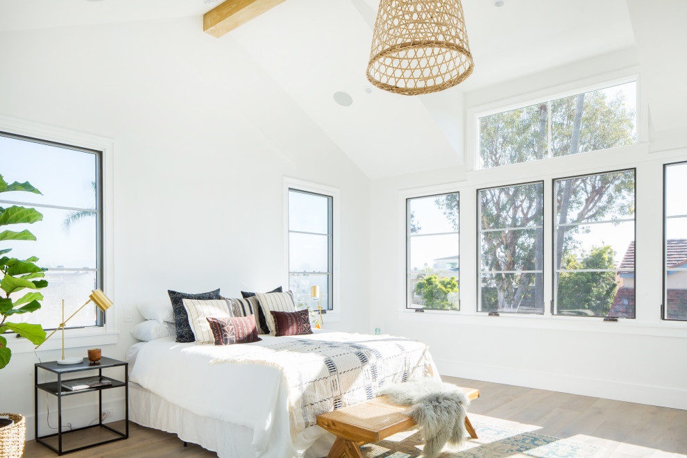 Design ideas for a large country master bedroom in Orange County with white walls and light hardwood floors.