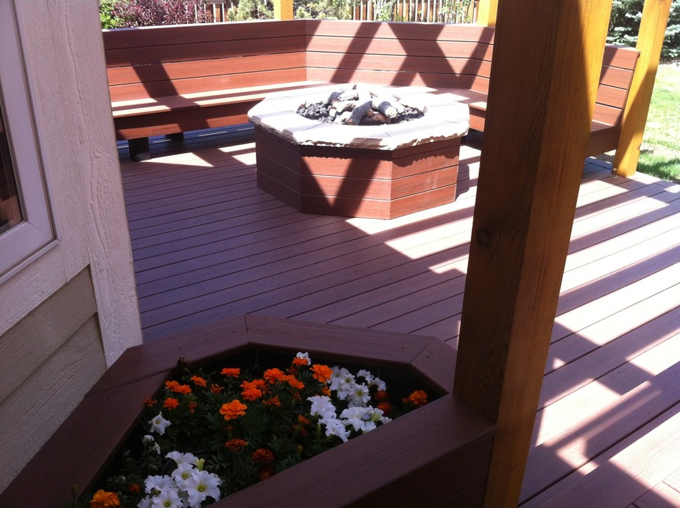 Deck - large rustic backyard deck idea in Denver with a fire pit