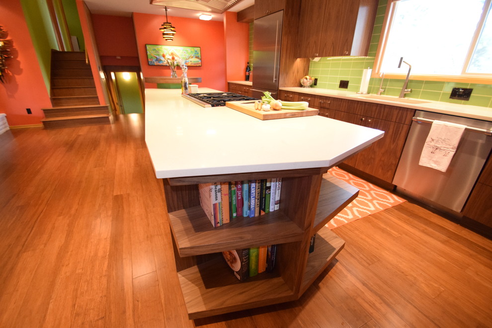 Large midcentury galley eat-in kitchen in Portland with an undermount sink, flat-panel cabinets, dark wood cabinets, quartz benchtops, green splashback, subway tile splashback, stainless steel appliances, bamboo floors, with island and brown floor.