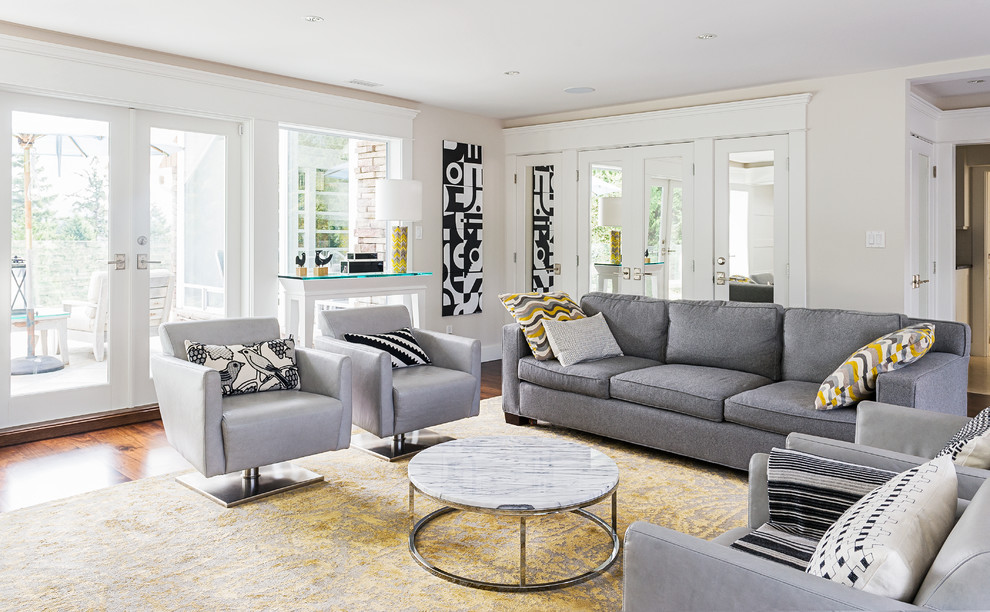 Contemporary living room in Vancouver with beige walls and medium hardwood floors.