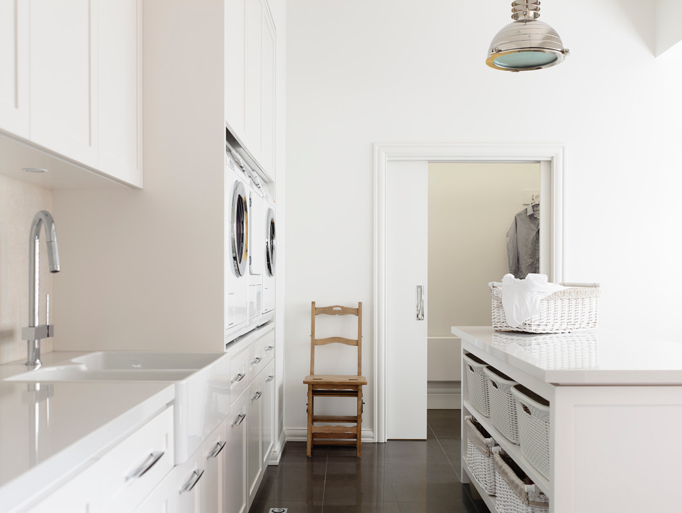 Photo of a transitional laundry room in Melbourne with a farmhouse sink.