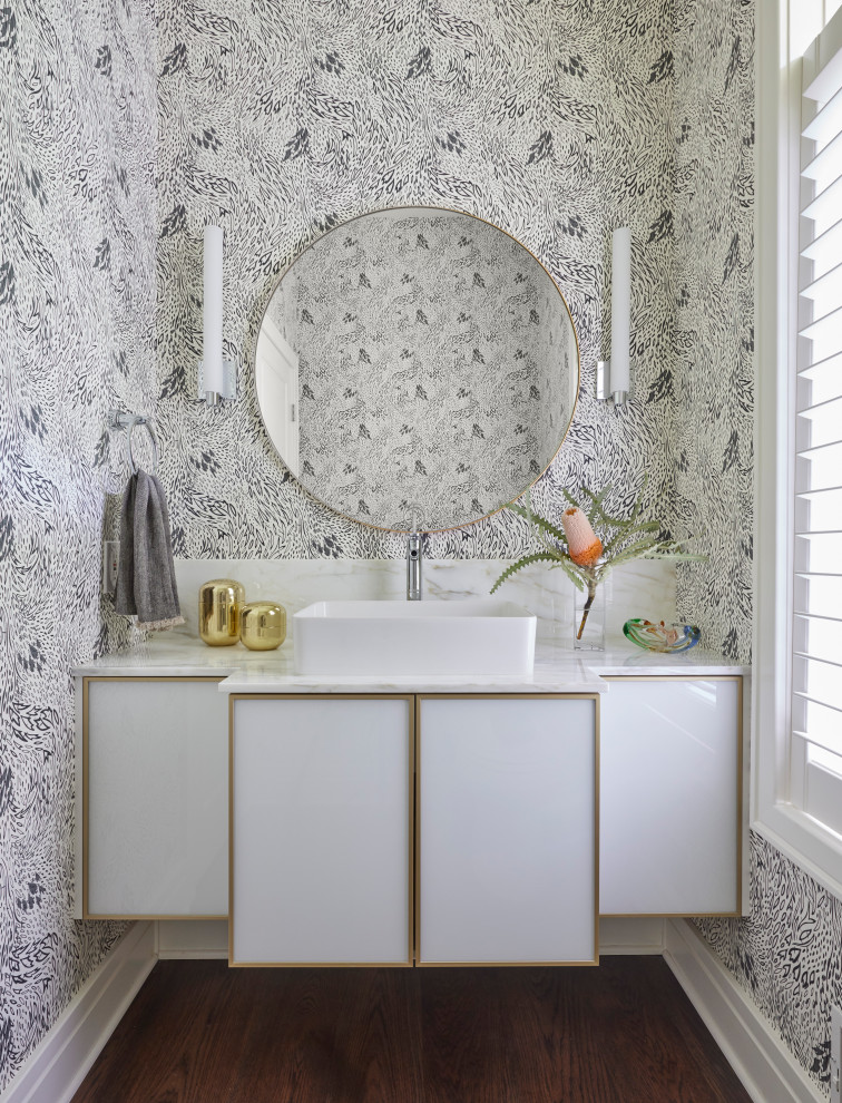 Inspiration for a small eclectic bathroom in Grand Rapids with glass-front cabinets, white cabinets, dark hardwood floors, a vessel sink, engineered quartz benchtops, brown floor, white benchtops, a single vanity, a floating vanity and wallpaper.