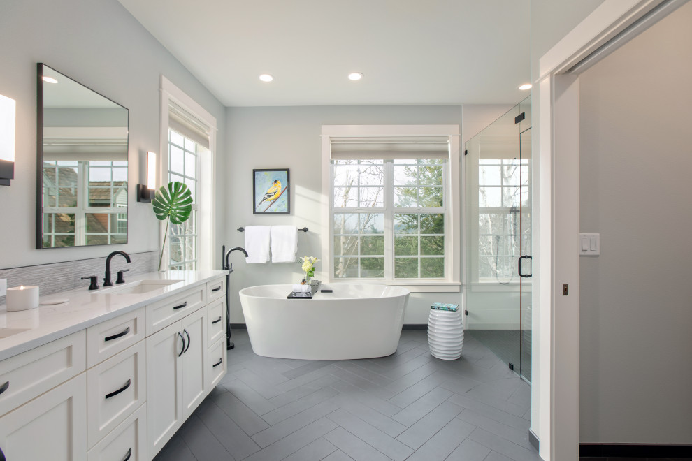 Photo of a mid-sized contemporary master bathroom in Portland with shaker cabinets, white cabinets, a freestanding tub, a curbless shower, ceramic tile, grey walls, an undermount sink, quartzite benchtops and white benchtops.