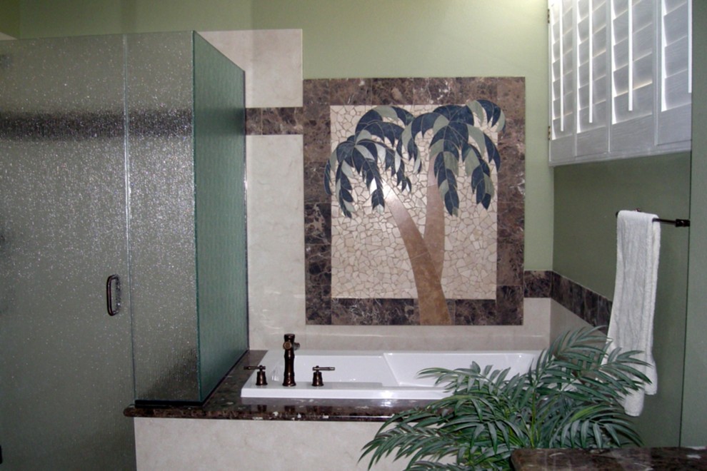 Photo of a large tropical master bathroom in Orange County with an undermount sink, raised-panel cabinets, dark wood cabinets, marble benchtops, a drop-in tub, a corner shower, a two-piece toilet, beige tile, porcelain tile, white walls and porcelain floors.