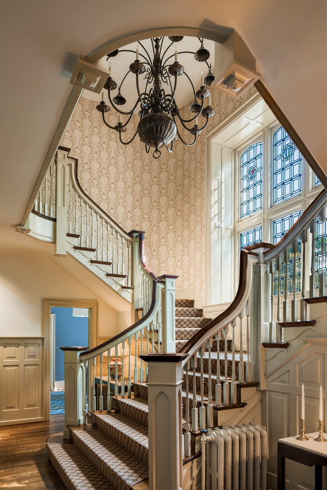 Traditional l-shaped staircase in Philadelphia with wood railing.