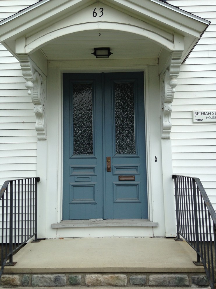 This is an example of a mid-sized traditional front door in Portland Maine with a double front door and a blue front door.