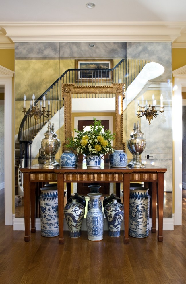 Inspiration for a traditional entryway in DC Metro with yellow walls and brown floor.