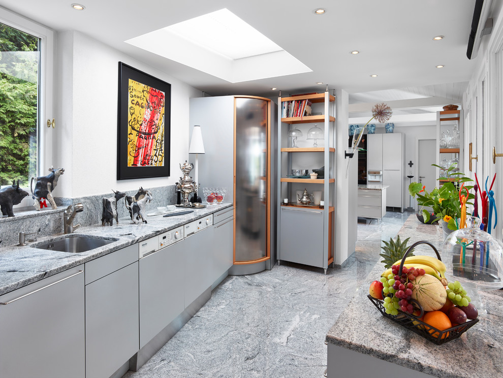Photo of a mid-sized contemporary galley separate kitchen in Other with an undermount sink, flat-panel cabinets, grey cabinets, panelled appliances, grey floor, granite benchtops, multi-coloured splashback, stone slab splashback and no island.