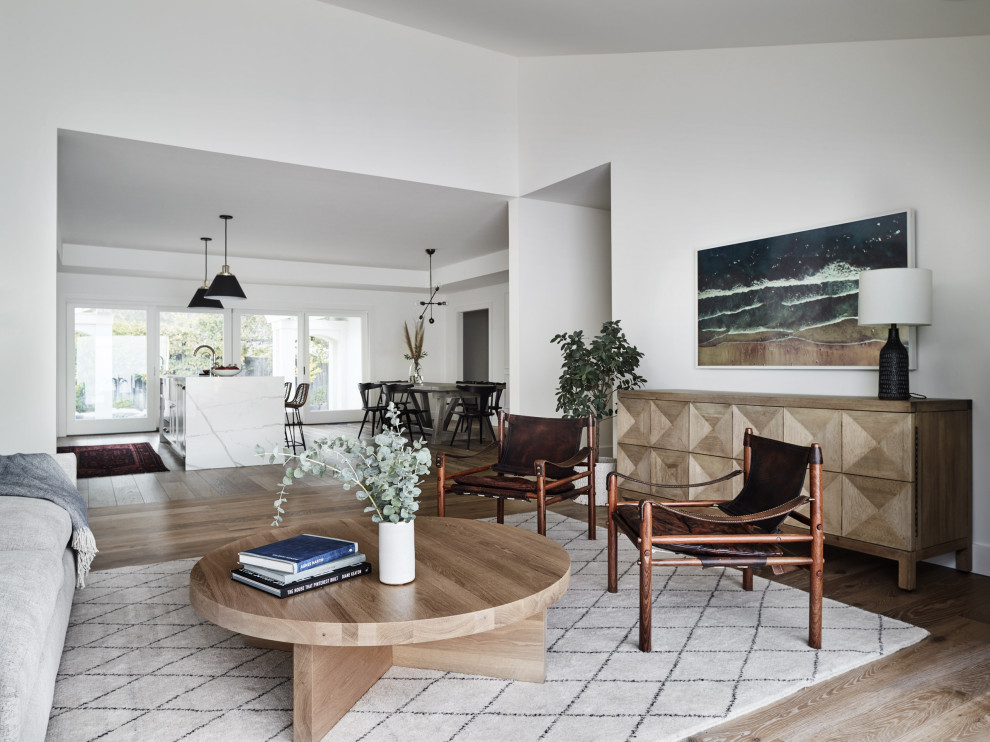 Design ideas for a large transitional open concept living room in Chicago with white walls and brown floor.