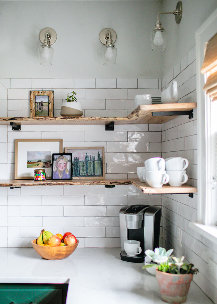 Mid-sized transitional medium tone wood floor and brown floor kitchen photo in Chicago with a farmhouse sink, shaker cabinets, green cabinets, quartz countertops, white backsplash, subway tile backsplash, stainless steel appliances, an island and white countertops