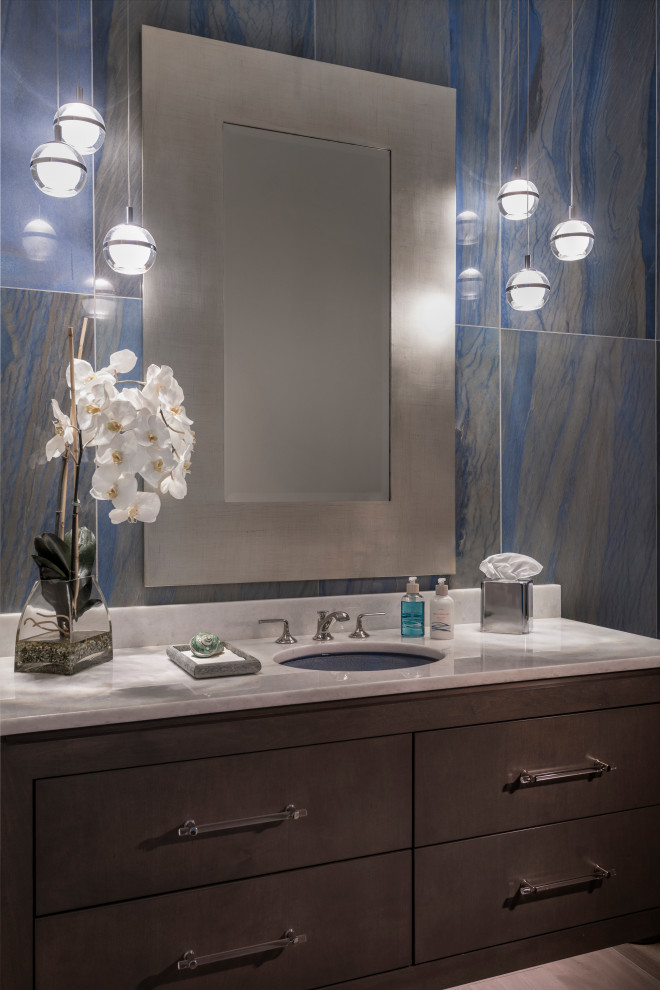 Photo of a mid-sized beach style powder room in Other with flat-panel cabinets, brown cabinets, stone tile, an undermount sink, quartzite benchtops, white benchtops and a floating vanity.